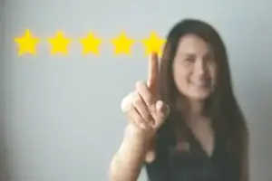 Smiling woman with finger raised giving a 5-star review